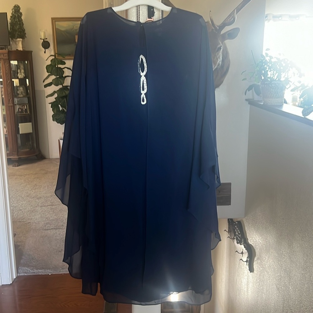 Dk blue with diamond accent, sheer cape. Wore only once to so sons wedding